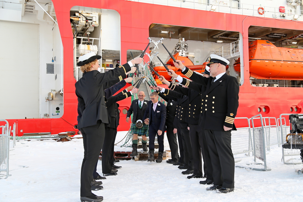 Eric Bourne and Stephen Carpenter celebrate their wedding with the crew of the RRS Sir David Attenborough